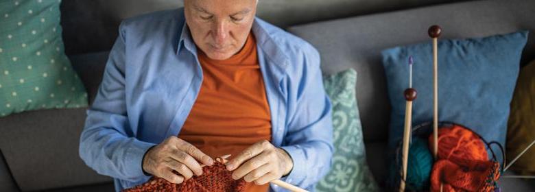man relaxed while knitting